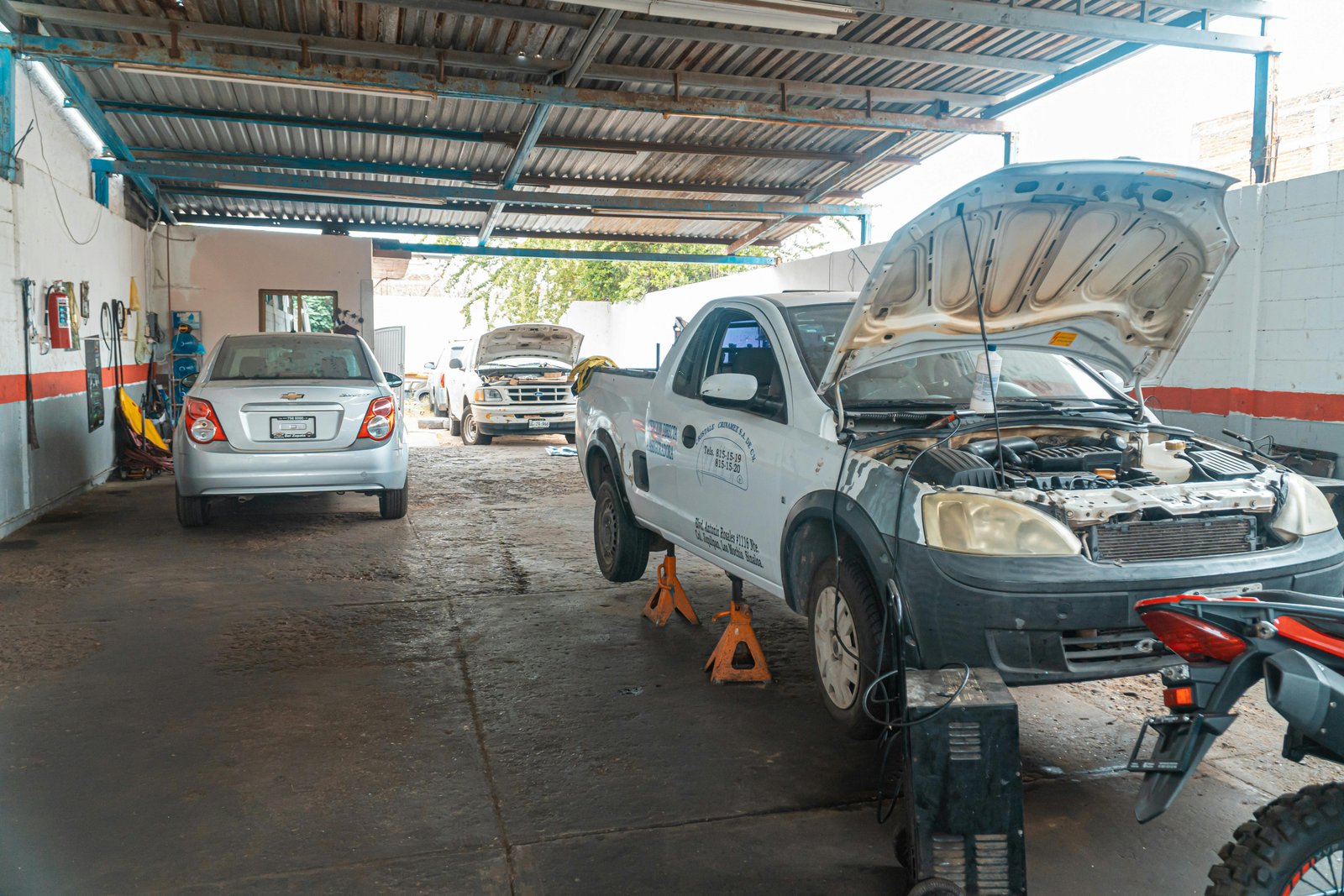 Mechanic inspecting a vehicle in workshop
